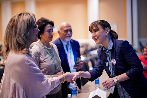 AILA members shake hands with AILA BOG member Mahsa Khanbabai