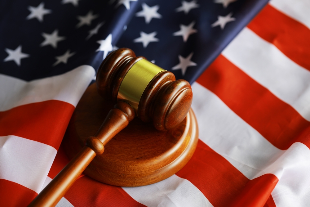 Image of a gavel resting on an American flag.