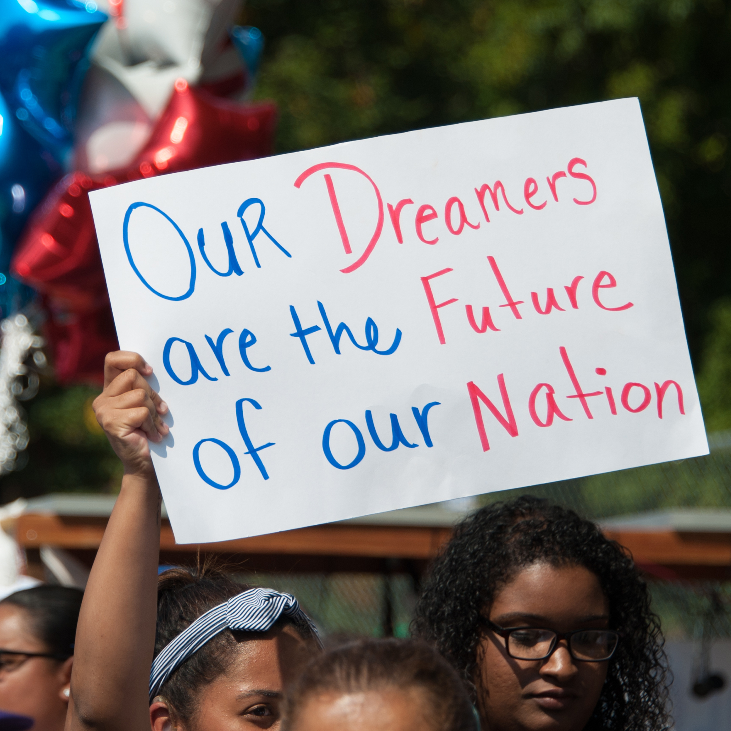 Image of a protester holding up a sign.