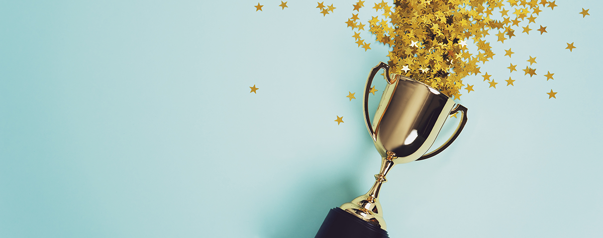 Trophy with gold stars falling out of it